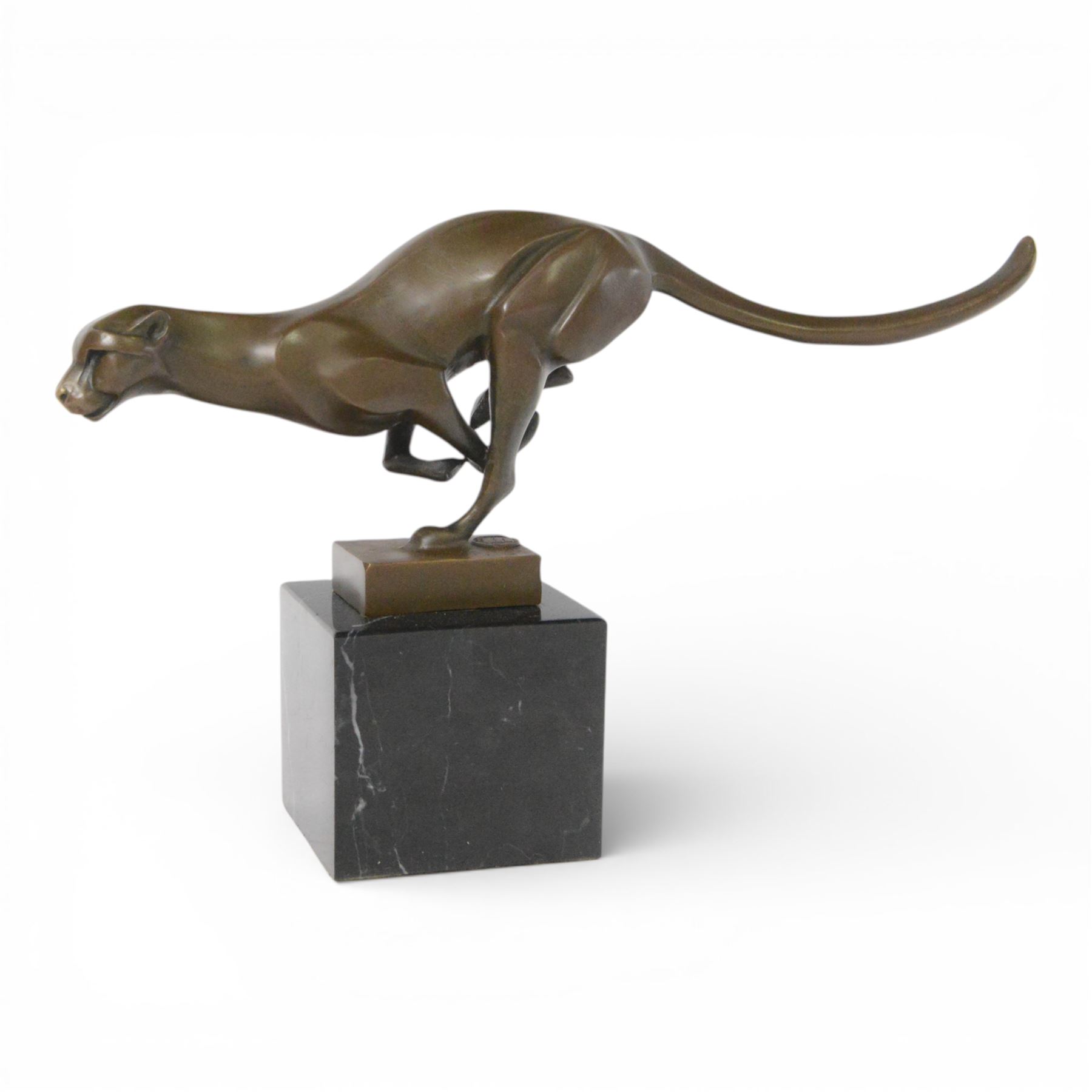 Bronze figure, modelled as a running cheetah, with foundry mark, raised upon a marble base, H20cm
