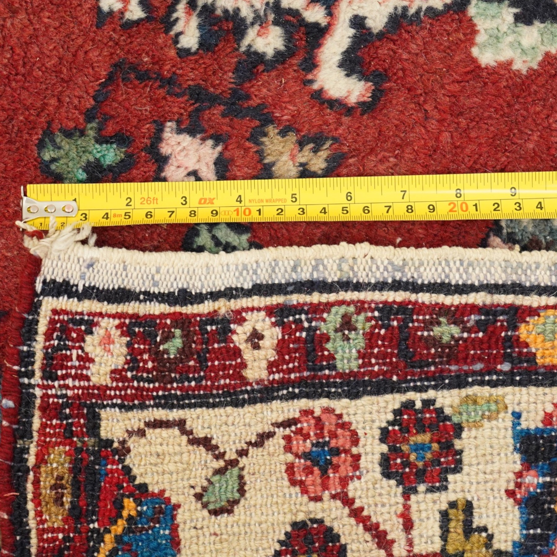 Small Persian crimson ground Hamadan rug, decorated with central medallion surrounded by stylised foliate motifs with repeating guard lines