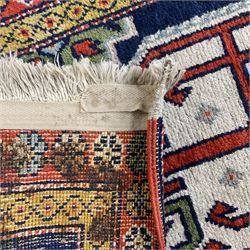 Small Persian indigo ground rug or mat, the field decorated with three geometric medallions, the border decorated with repeating flower heads