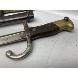 French Model 1866 Chassepot bayonet with 57cm curving fullered steel blade dated 1873 No.L63963; in steel scabbard with conforming number L71.5cm overall; and French St. Etienne Gras bayonet dated 1878 No.K10674 in steel scabbard numbered 79437 (2)
