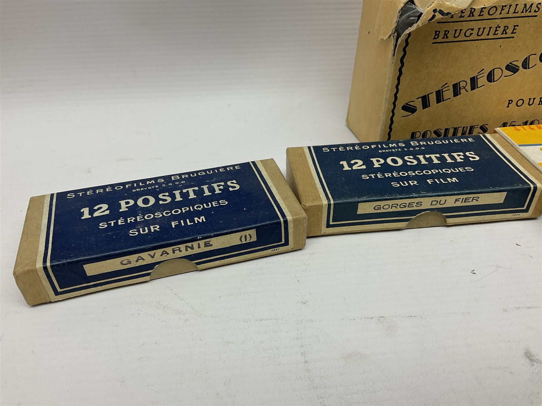 Two Stereofilms Bruguiere stereoscopes with seven boxes of related stereo positive slides to include one colour example entitled ‘Si Versailles m’etait conte’ Serie No.1, all in original boxes