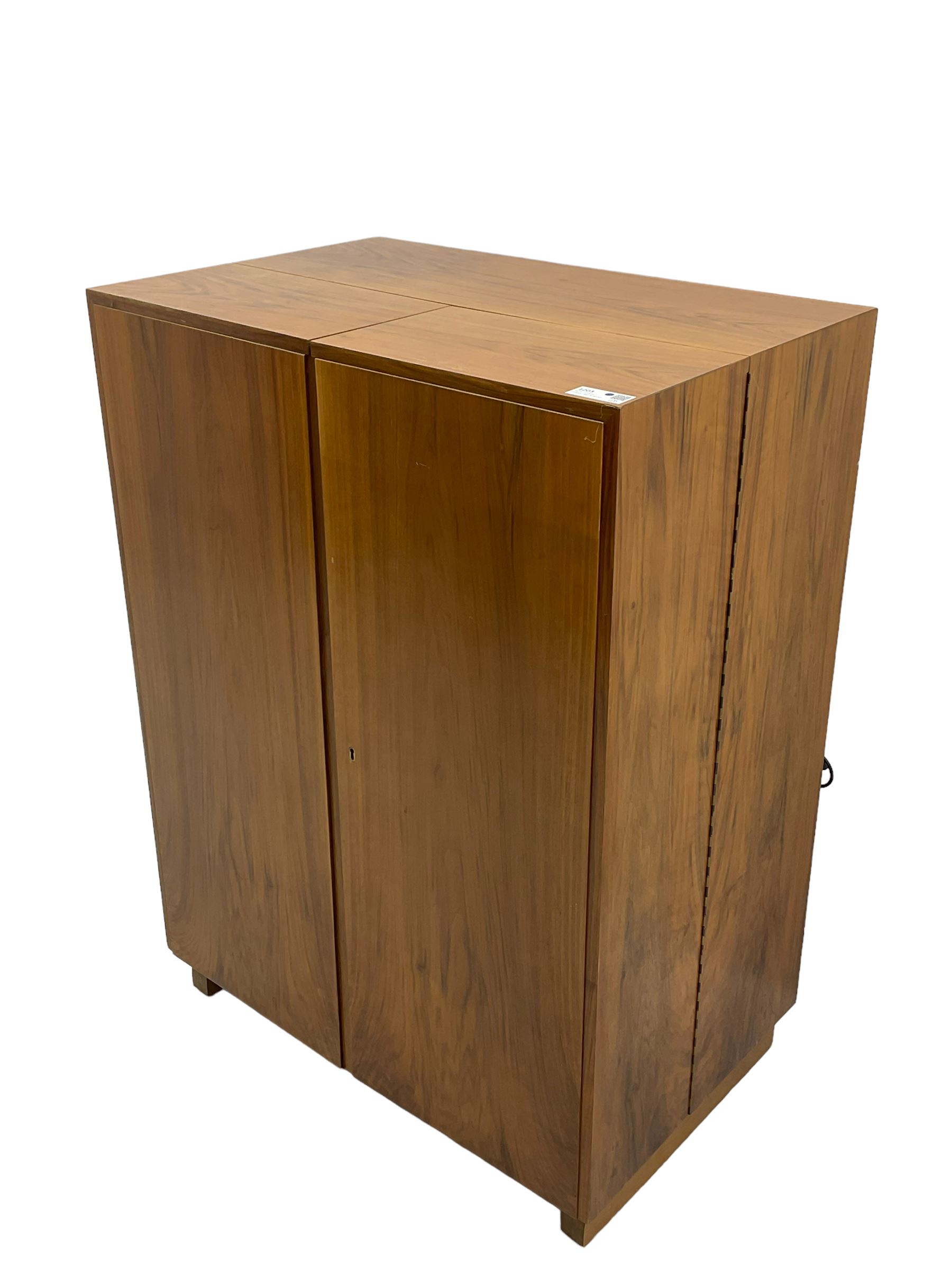 Mid-20th century walnut 'Magic Box' design metamorphic desk cabinet, two doors open to reveal sliding desk with drop leaves, document divisions and internal lamp, on sledge supports 