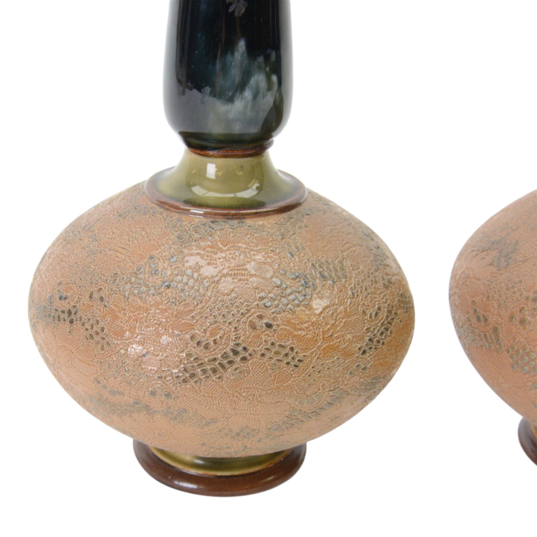 Pair of Royal Doulton vases by Christine Abbot, of squat circular form with elongated neck and flared rim, the body decorated with floral design, H26cm