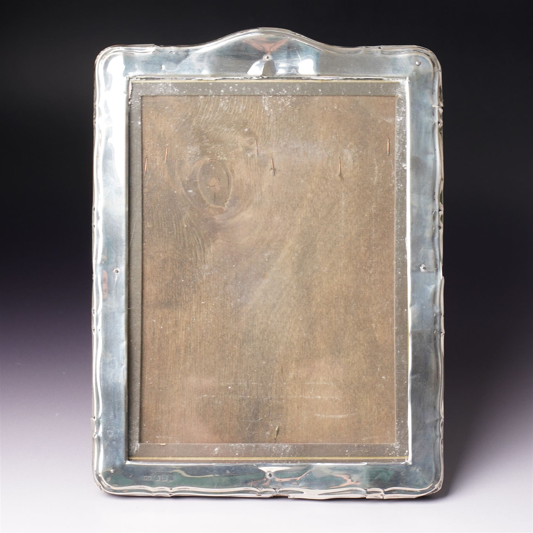 Silver upright photograph frame of plain design, aperture size 21cm x 15cm marks rubbed