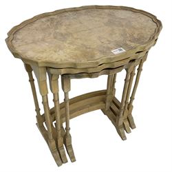 Mid 20th century bleached walnut nest of three tables, oval piecrust tops on turned supports