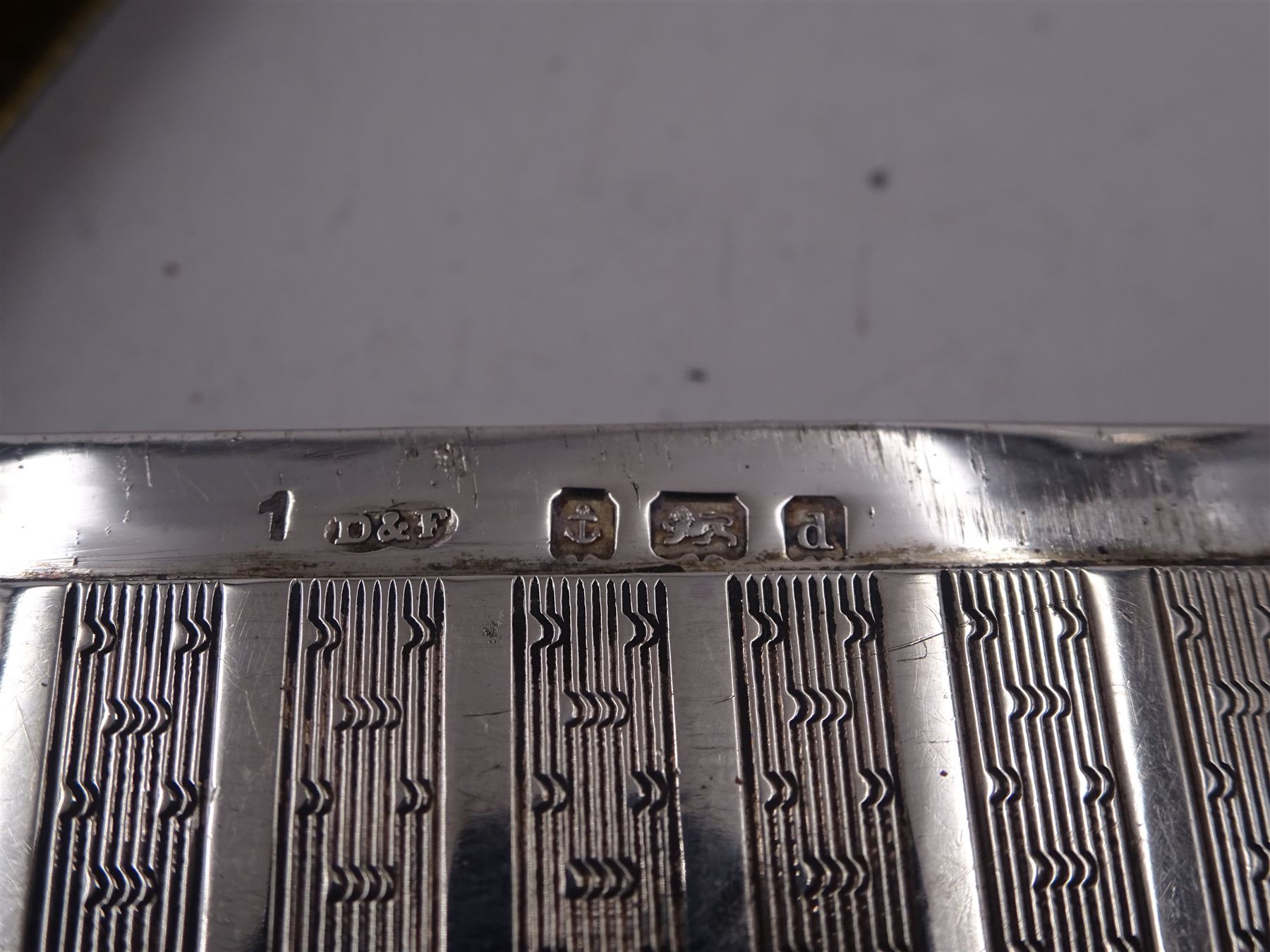 Edwardian silver card case, of rectangular form with shaped outer edge and engine turned linear decoration to body, with central monogrammed circular cartouche, H9.2cm, hallmarked Deakin & Francis Ltd, Birmingham 1903, together with a 1920s silver jewellery box, of plain oval drum form, engraved 'May' to hinged cover, opening to reveal part silk lined interior, upon four pad feet, H4.5cm, hallmarked J & R Griffin Ltd, Chester 1922 and a 1930s silver box, of circular form, engraved with monogram to hinged cover, hallmarked Barker Brothers Silver Ltd, Birmingham 1932