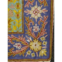  An Iranian lines silk tapestry wall hanging, the oblong centre divided into forty-eight small rectangular panels each with multicoloured floral decoration on various coloured grounds, within a purple ground border of stylised flowers W120cm L191cm Provenance: This lot was gifted to the vendor who worked for the Royal Family of Oman  