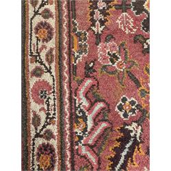 Belgian Sultan woollen ground rug, central navy field densely decorated with floral sprays and geometric patterns (192cm x 135cm); handwoven tribal terracotta ground rug (121cm x 71cm); Persian crimson ground runner, all over stylised floral and foliate motifs (266cm x 94cm)