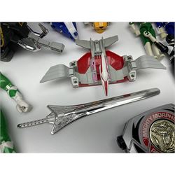 Collection of early 90s Mighty Morphin’ Power Rangers Zords, figures and accessories. Titanus the Carrier Zord, marked Bandai 1991; Green Dragonzord, incomplete; 1994 White Tigerzord with original instruction manual; 1993 Triceratops Dinozord, Mastodon Dinozord and Sabertooth Tiger Dinozord, Pterodactyl Dinozord, missing guns; with 1993 Power Morpher and original Power Coins, with further related figures, accessories and weapons