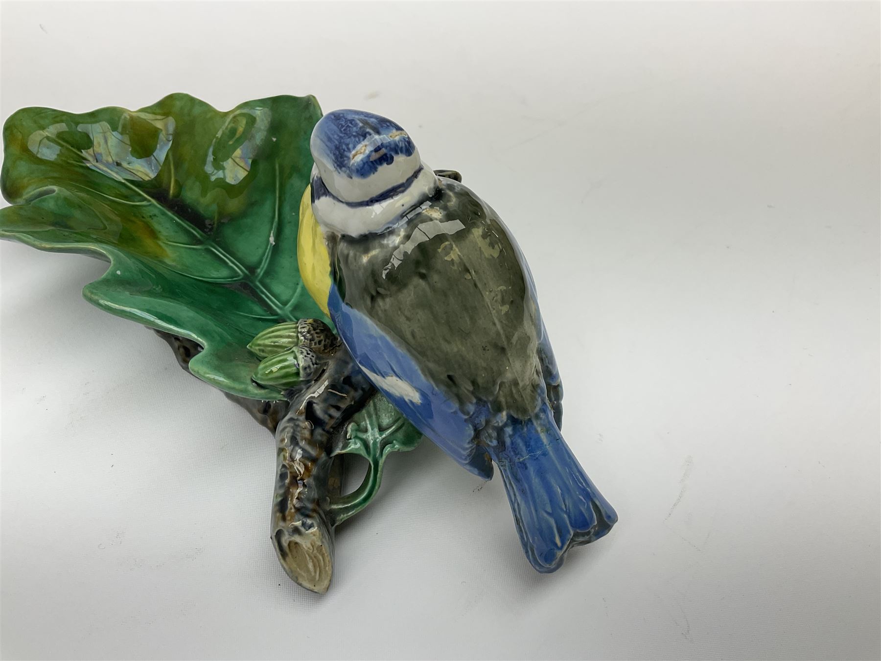 Minton majolica leaf dish, modelled as a Blue Tit perched on a branch with acorns and an oak leaf, date cypher for 1868, impressed marks beneath, L21cm. 