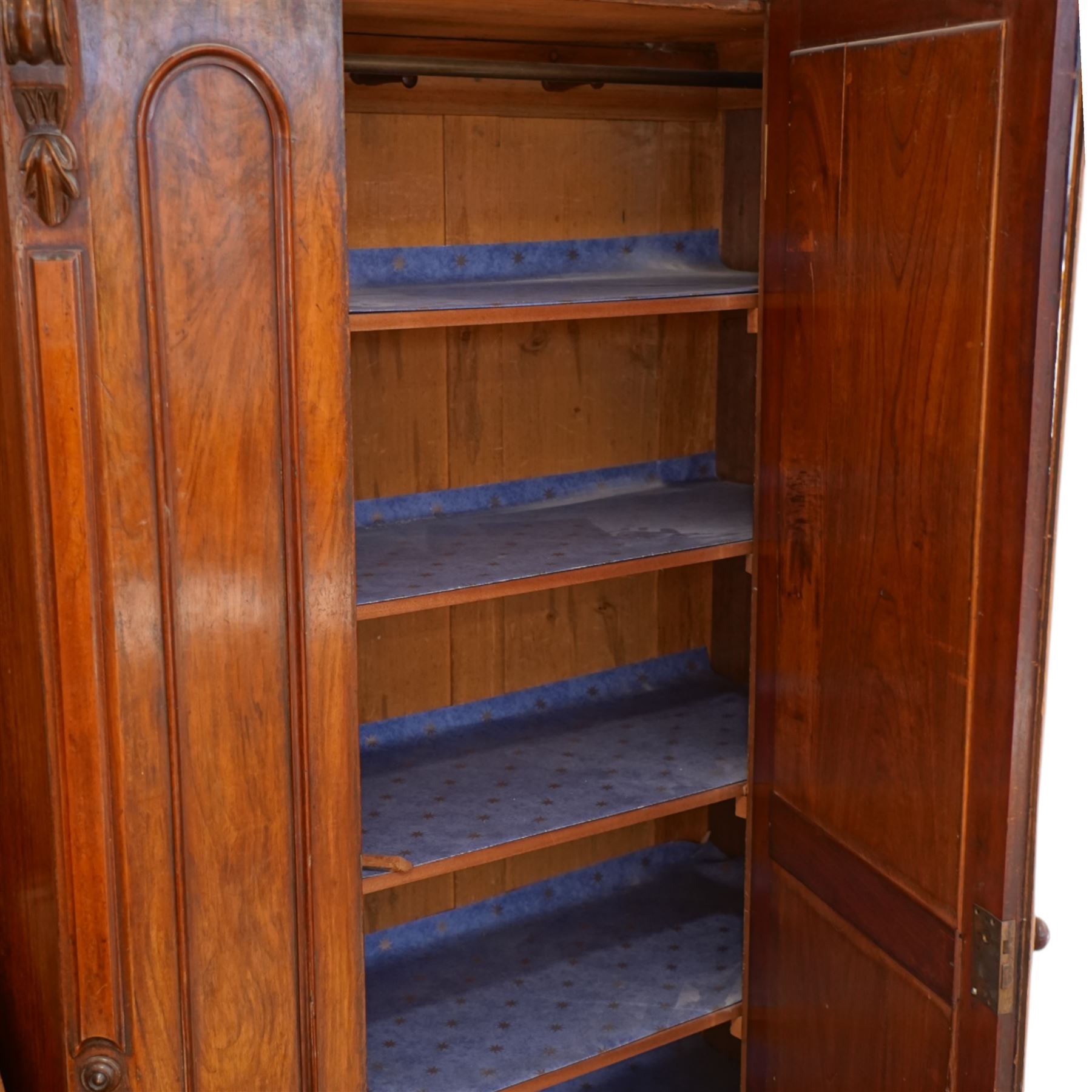 Victorian late 19th-century mahogany wardrobe, moulded cornice with rounded corners above arched mirror door, flanked by arched panels and side with carved corbels, on plinth base  