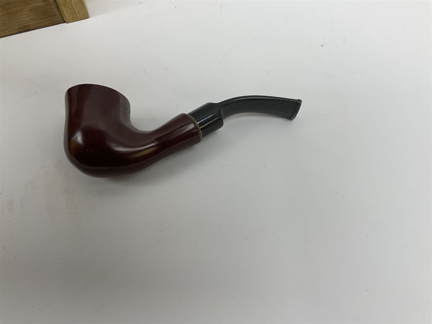 Pipes and two tiered wooden rack together with eleven pipers, including briar pipe carved as a wolf, Sea Dog straight pipe, John Brumfit pipe, meerschaum pipe ect, pipe rack H29.5cm