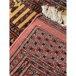 Afghan red ground runner rug, the field decorated with eight Gul motifs, the multi-band with repeating lozenges 
