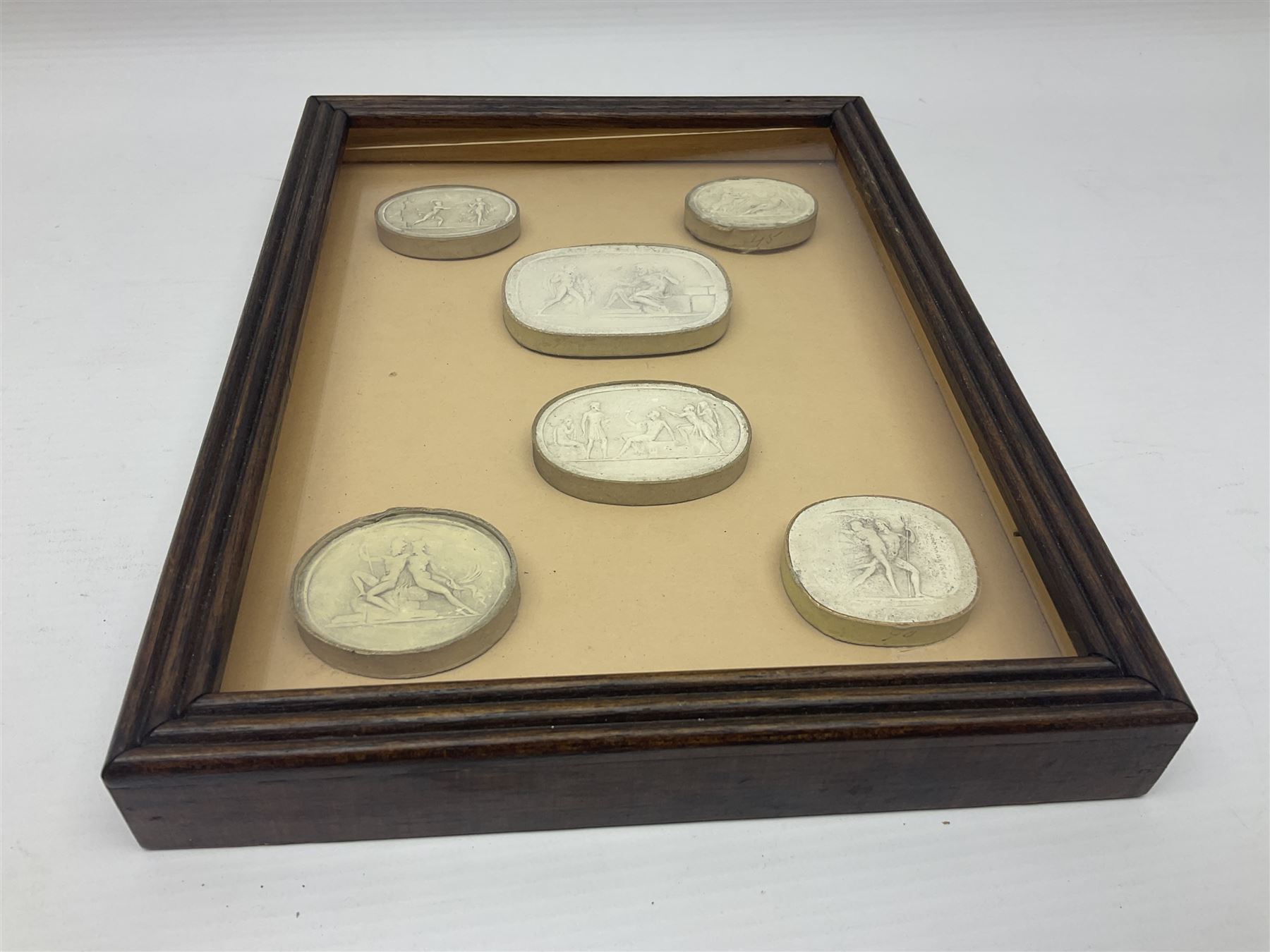 Set of six 19th century Grand Tour plaster intaglios, each depicting classical figures, frame H25cm, W19cm