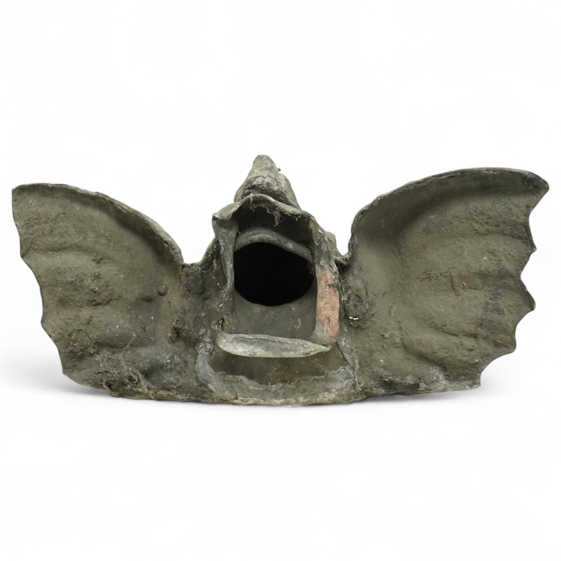 19th century cast lead fountain head with spout in the form of a grotesque fish, the mouth agape with rows of teeth, flanked by protruding fins 