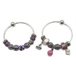  Two silver Pandora charm bracelets, with eighteen Pandora charms total, all stamped 925 ALE   