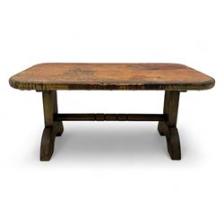 Rectangular oak coffee table, rectangular top with tan leather cover decorated with naturalistic scene, on rectangular end supports and curved feet united by turned stretcher 