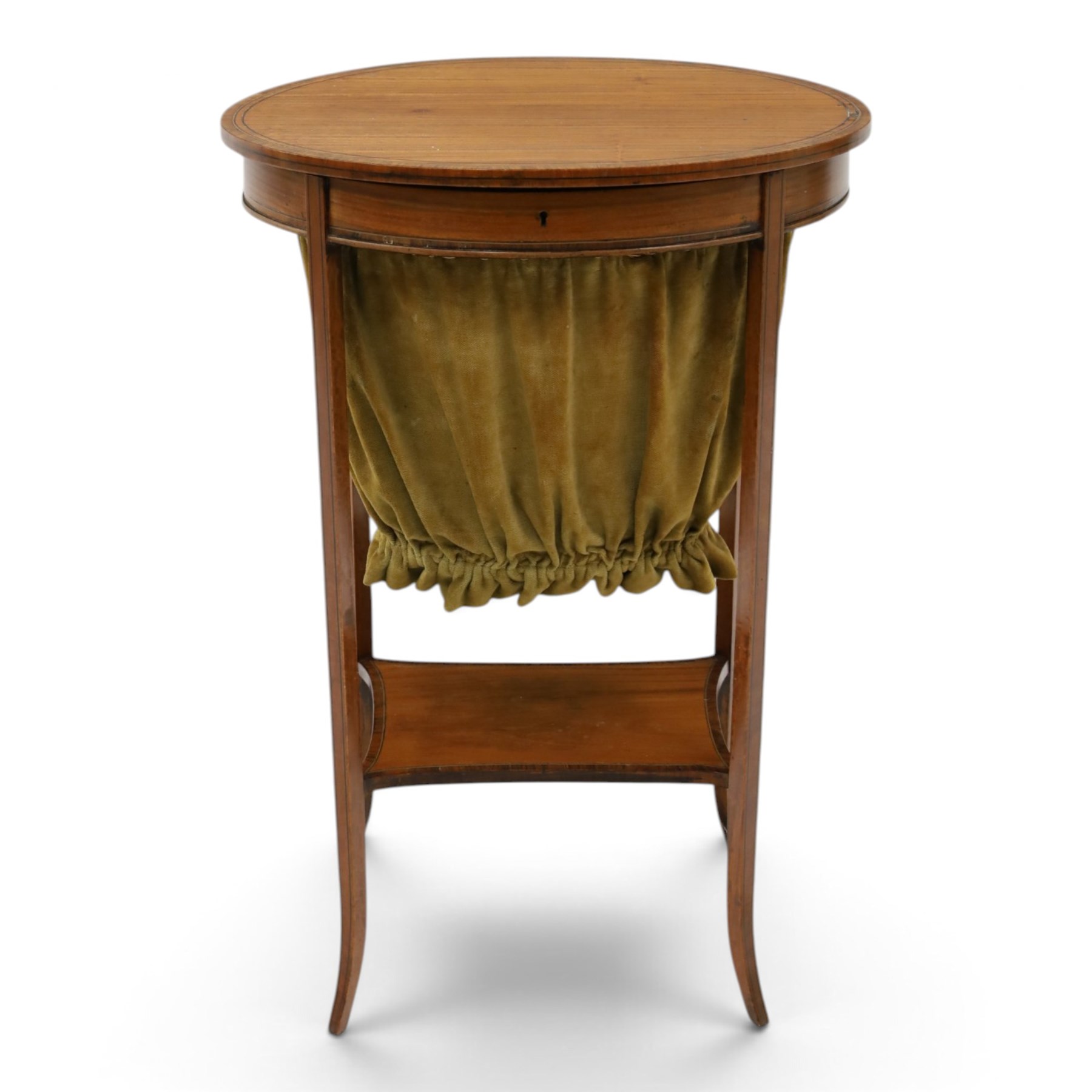 Edwardian inlaid satinwood oval sewing or work table, crossbanded and ebony-strung hinged top enclosing fitted compartment and olive-green upholstered well, raised on square tapering splayed supports united by under-tier 
