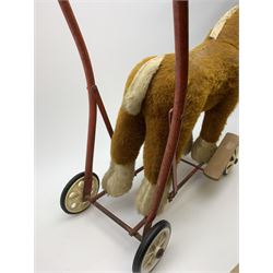 Pedigree push along plush covered horse 1950s-60s with red tubular metal framework and beech foot rests H25