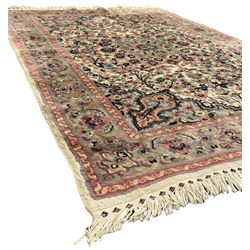 Persian design ivory and pink ground rug, the field decorated with central rosette medallion surrounded by trailing branches and flower heads, repeating border within guard stripes 