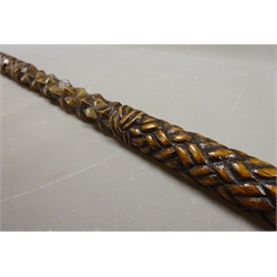  Carved wooden walking stick, rope twist facet and plait carved shaft with with walrus ivory carved handle, L96cm  