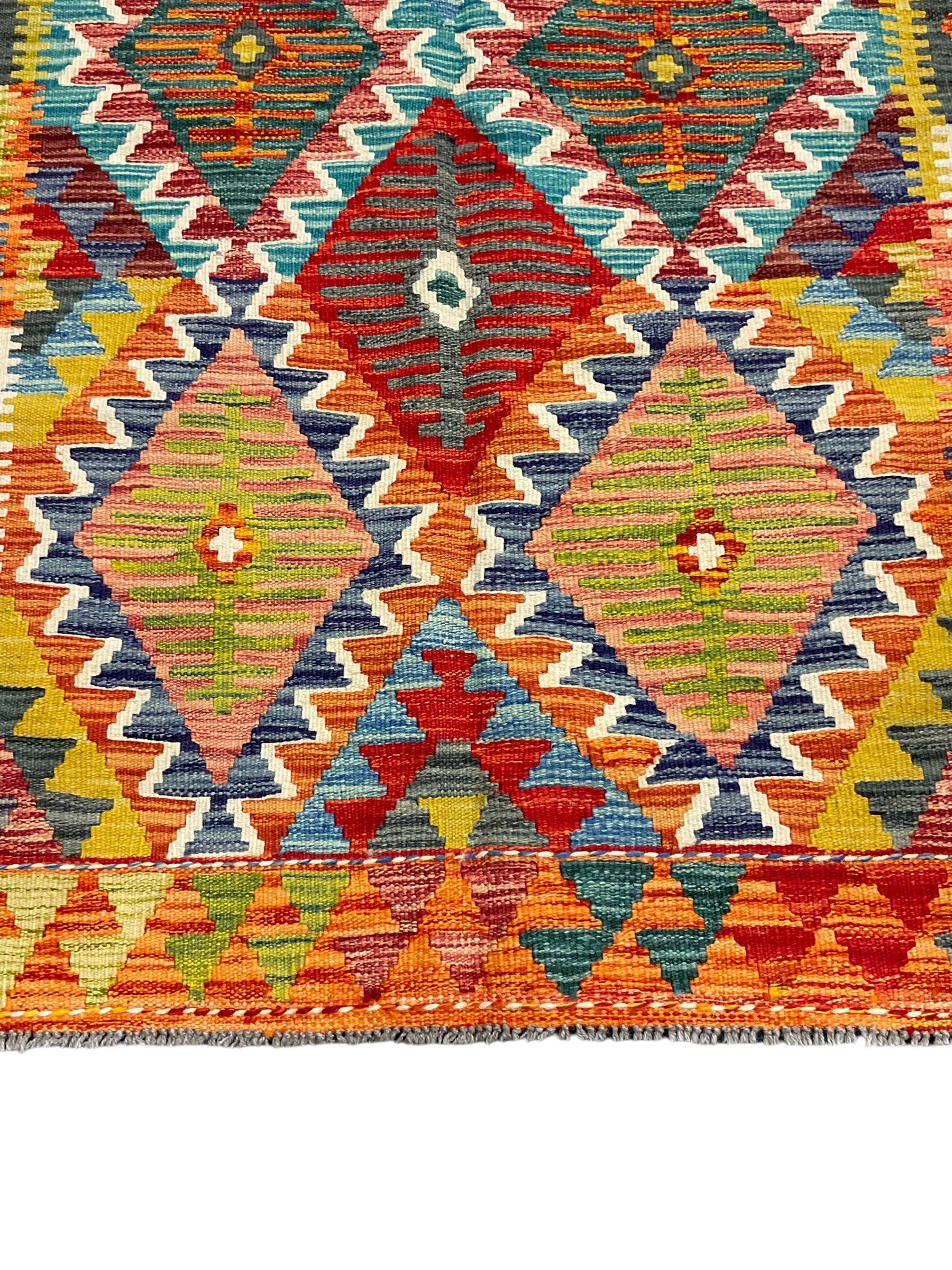 Chobi Kilim rug, multi-coloured ground in oranges, blues and greens, overall geometric design 