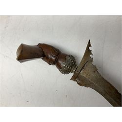 Malayan Kris with 36cm typically wavy blade with cast metal mounted carved hardwood handle L46.5cm overall; a similar kris with 35cm wavy blade and brass mounted carved hardwood handle; and another with 49cm oval section straight blade; all in wooden sheaths (3)