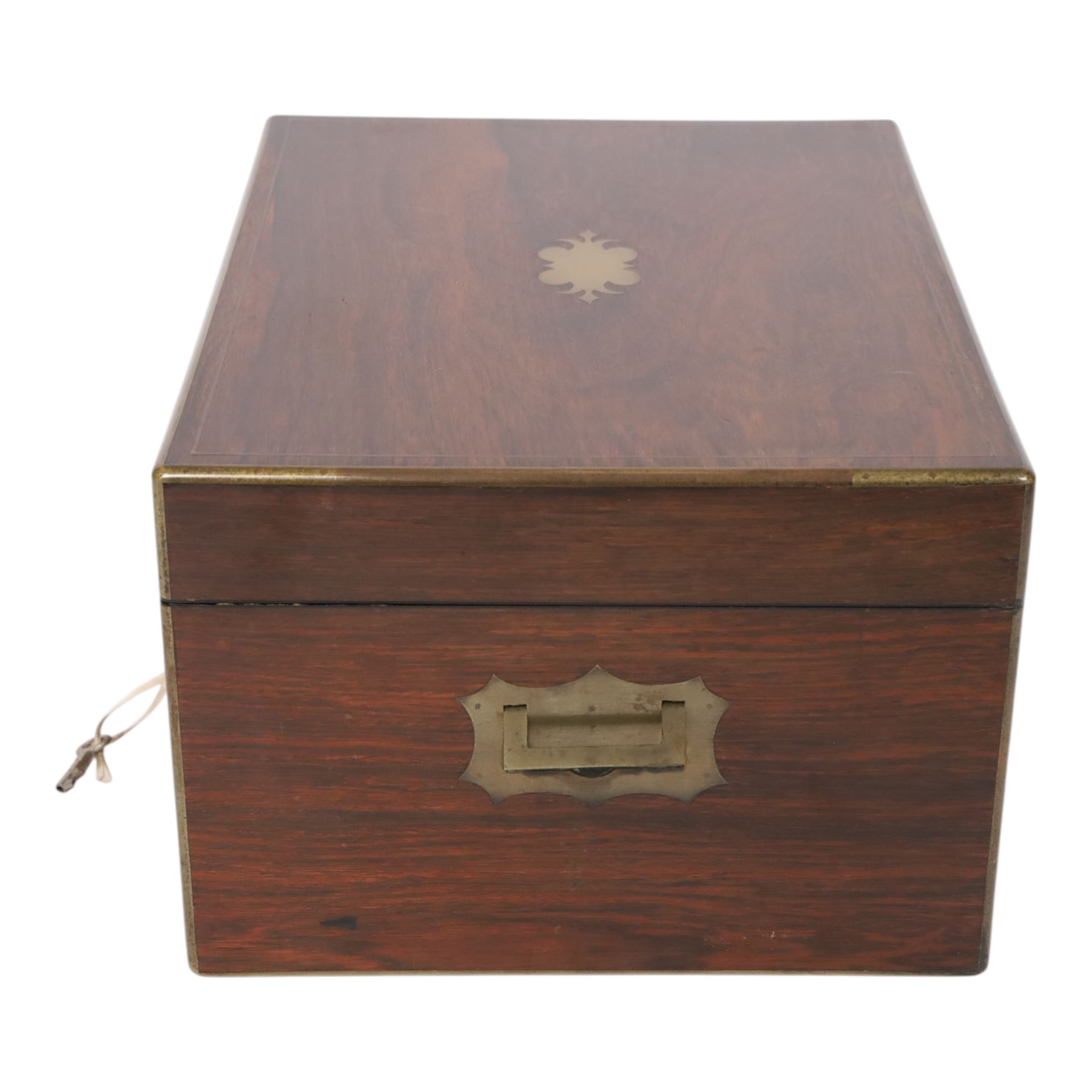  Victorian brass inlaid rosewood dressing table box, retailed by F.L. Hausburg, Liverpool, the lid centred by a brass cartouche, opening to reveal letter store to lid underside, above a fitted interior, with ten mounted cut glass jars, bottles and manicure set, within lift out leather trays, above jewellery drawer, with key, H17cm D24cm