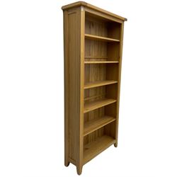 Tall light oak bookcase, fitted with five shelves