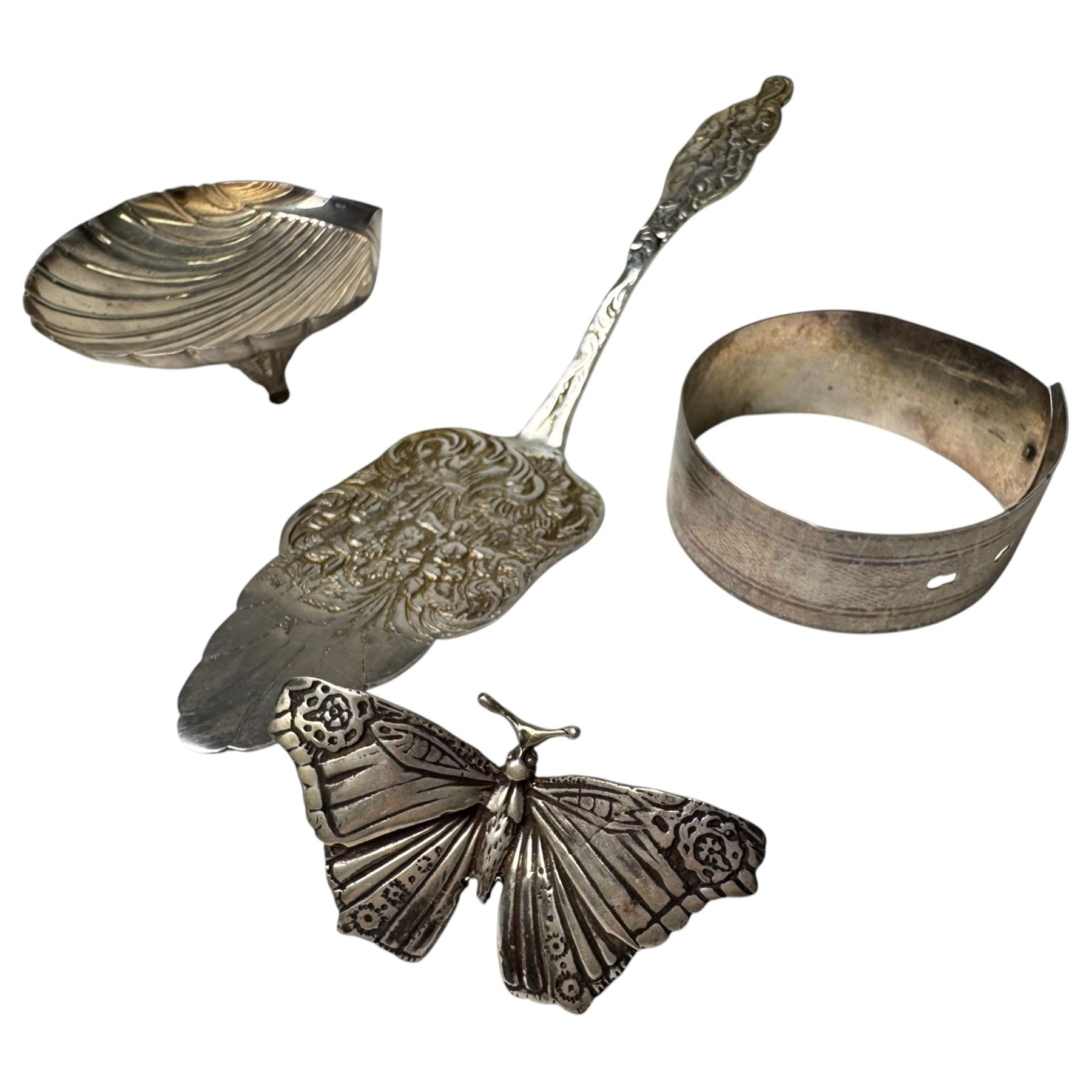 Continental silver, including shell butter dish, butterfly, pin dish and cake slice, all stamped 830, together with two Egyptian silver berry dishes and a bangle stamped sterling
