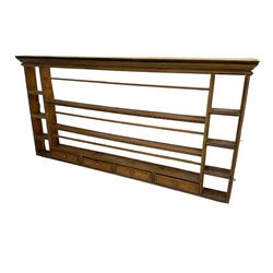 18th century pine wall hanging plate rack, projecting cornice over three tiers and four spice drawers, flanked by four tier shelves
