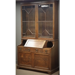  Early 20th century oak bureau bookcase, two astragal glazed doors enclosing three adjustable shelves, fall front with fitted interior, two open side compartments, three drawers and two cupboard doors on shaped plinth base, by 'Robson and Sons Ltd, Newcastle Upon Tyne', W127cm, H214cm, D52cm  