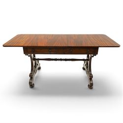 Fine 19th century figured mahogany sofa table, the rectangular twin drop-leaf top with rounded corners above two cock-beaded frieze drawers with opposing faux drawers, fitted with turned handles, raised on twin reeded and C-scroll-carved end supports with palmette-carved platform bases and compressed bun feet, united by a turned and foliate-carved stretcher