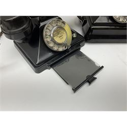 Two black Bakelite telephones of pyramid form with rotary dials, comprising The Telephone Demonstration Set model. 6al with base drawer and light bulb, and another larger with G.P.O FWR 58/2 stamped marks beneath, largest H18cm W20cm D16cm