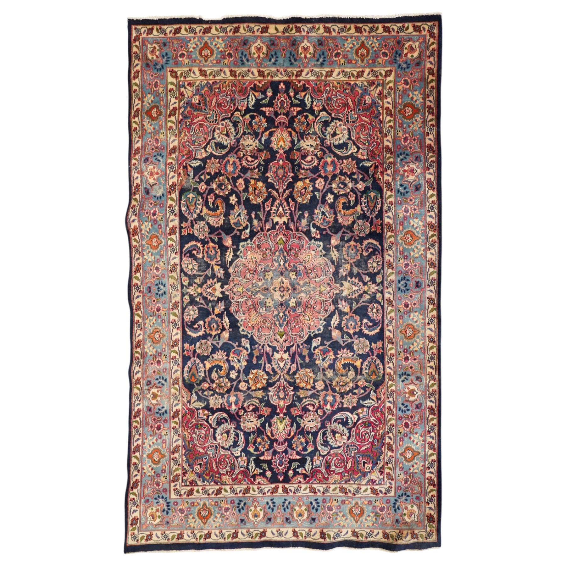Vintage Persian Tabriz indigo ground rug, the central floral medallion within a field woven with scrolling palmettes and plant motifs, with contrasting spandrels, the the cyan guard lines with scrolling floral patterns