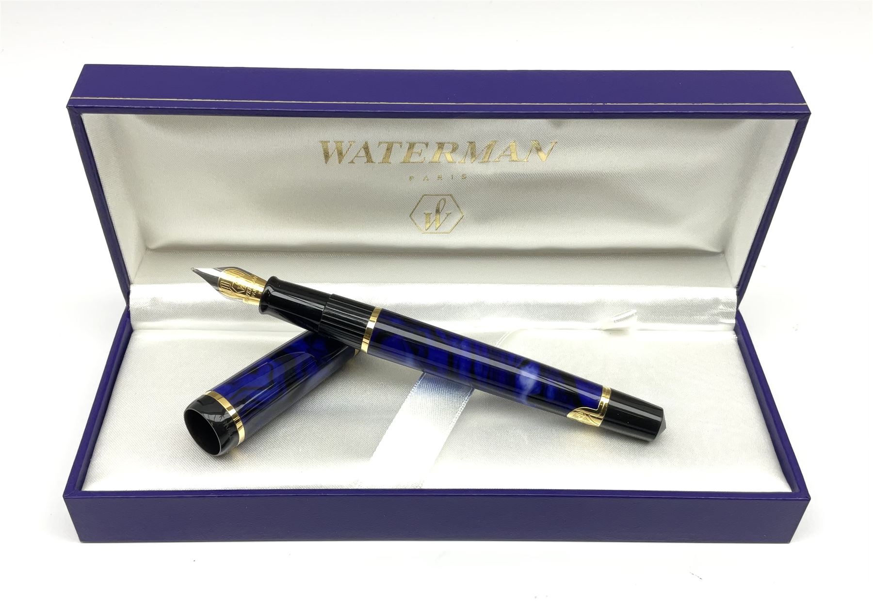 A Waterman Phileas fountain pen, with blue marbled effect body and gold coloured clip and banding, with makers fitted blue leather box, and outer card sleeve. 