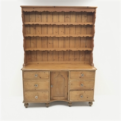 Victorian and later pine dresser, raised three tier plate rack, six graduating drawers flanking single cupboard, turned supports, W146cm, H196cm, D47cm