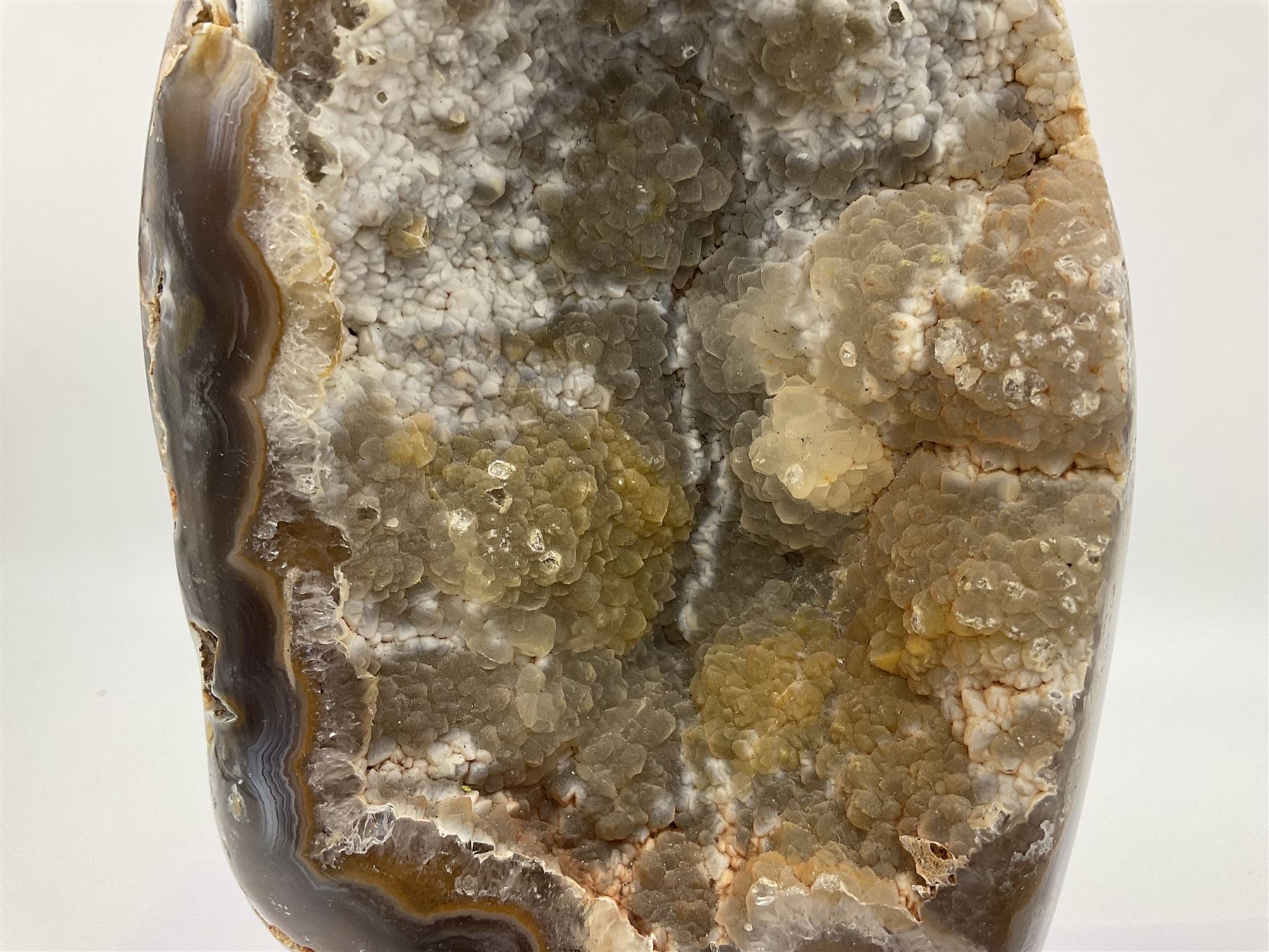 Agate crystal geode cluster, in brown and purple tones, upon a metal stand, H26cm