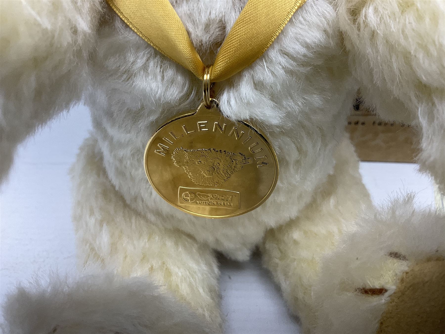 Modern Steiff teddy bear - The Millenium Bear No.34709 with golden pendant H32cm; in original box with paperwork; together with a Steiff ball-point pen in case sent to the vendor as compensation for a delay in receiving the bear.
