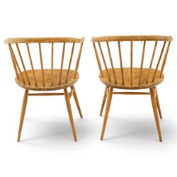 Ercol - pair of 'Cowhorn' elm carver chairs, curved back raised on nine stretchers, elm dished seats, raised on tapering supports