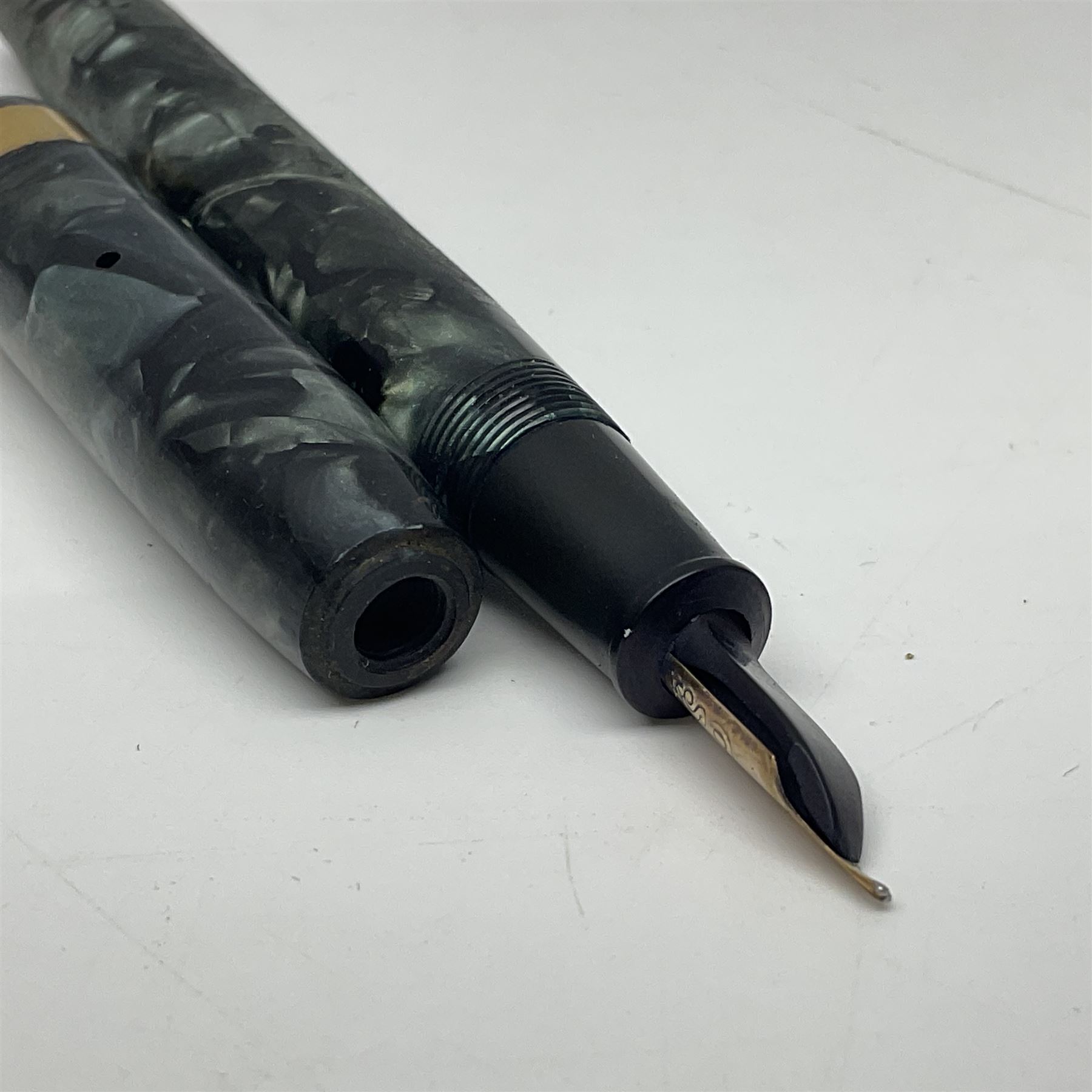 Four fountain pens, each with 14ct gold nibs, comprising Mentmore Paramount, Parker Junior Duofold, Conway Stewart marbleised pen and Waterman's, together with a 14ct gold Conway Stewart 5B nib