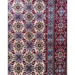 Northwestern Persian Hamadan carpet, hand-knotted, ivory field with an all-over Herati design of rosettes and serrated leaves within multiple borders, madder red with angular vine and rosette motifs, 375cm x 271cm 