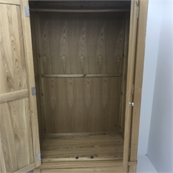 Solid oak wardrobe, two doors enclosing hanging rail above single drawer, stile supports, W111cm, H196cm, D63cm