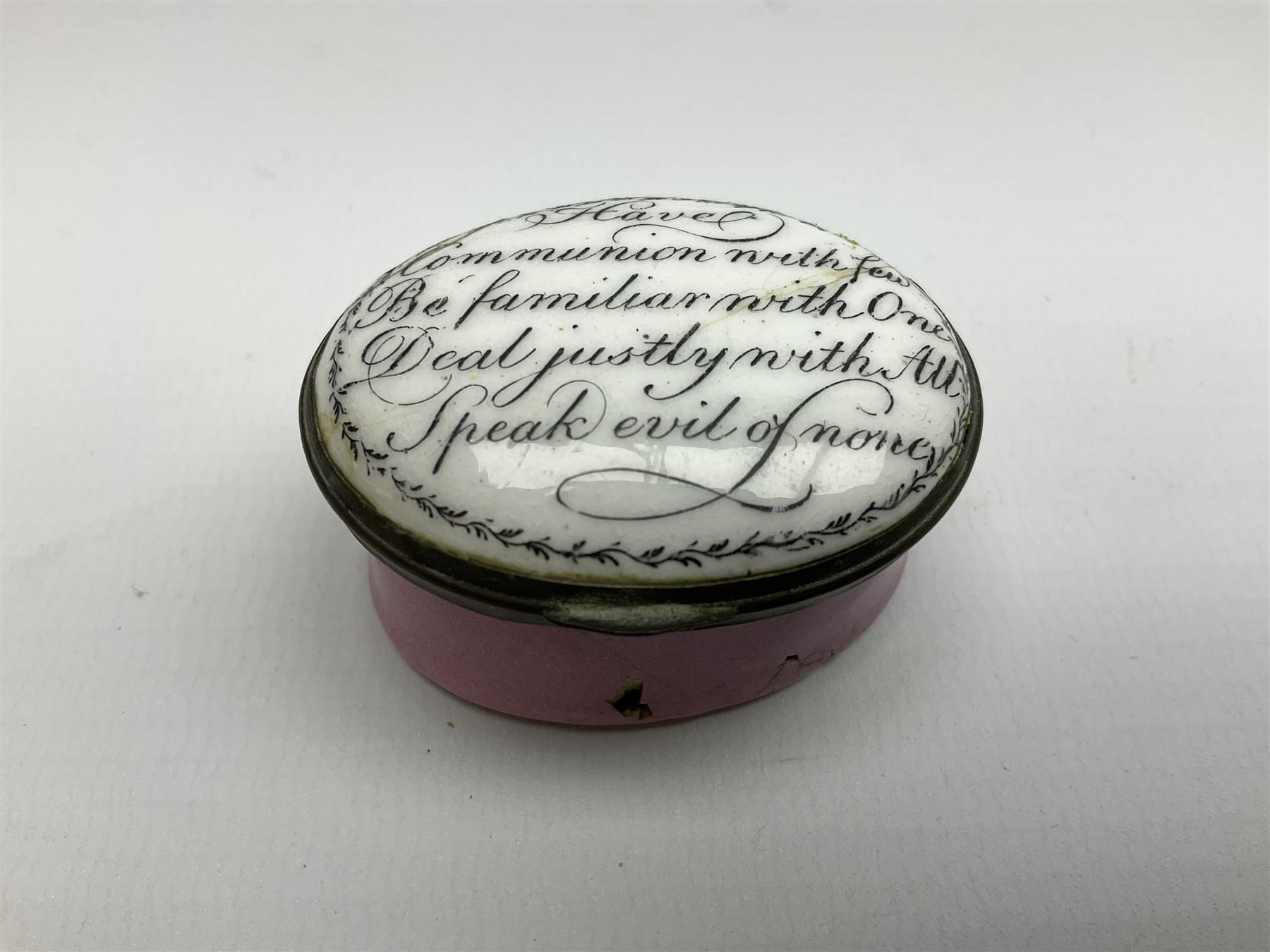Late 18th century Staffordshire enamel patch box, of oval form with pink base, the hinged cover inscribed 'Have Communion with few, Be familiar with One, Deal justly with All, Speak evil of none' upon a white ground, opening to reveal mirror beneath, W4cm