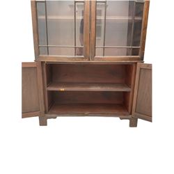 Late 19th century mahogany bookcase on cupboard, fitted with two glazed doors above two cupboards, adjustable shelves