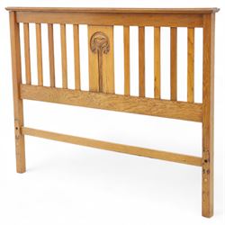 Art Nouveau oak double bed headboard, rectangular form with vertical slats centred by a carved stylised floral roundel