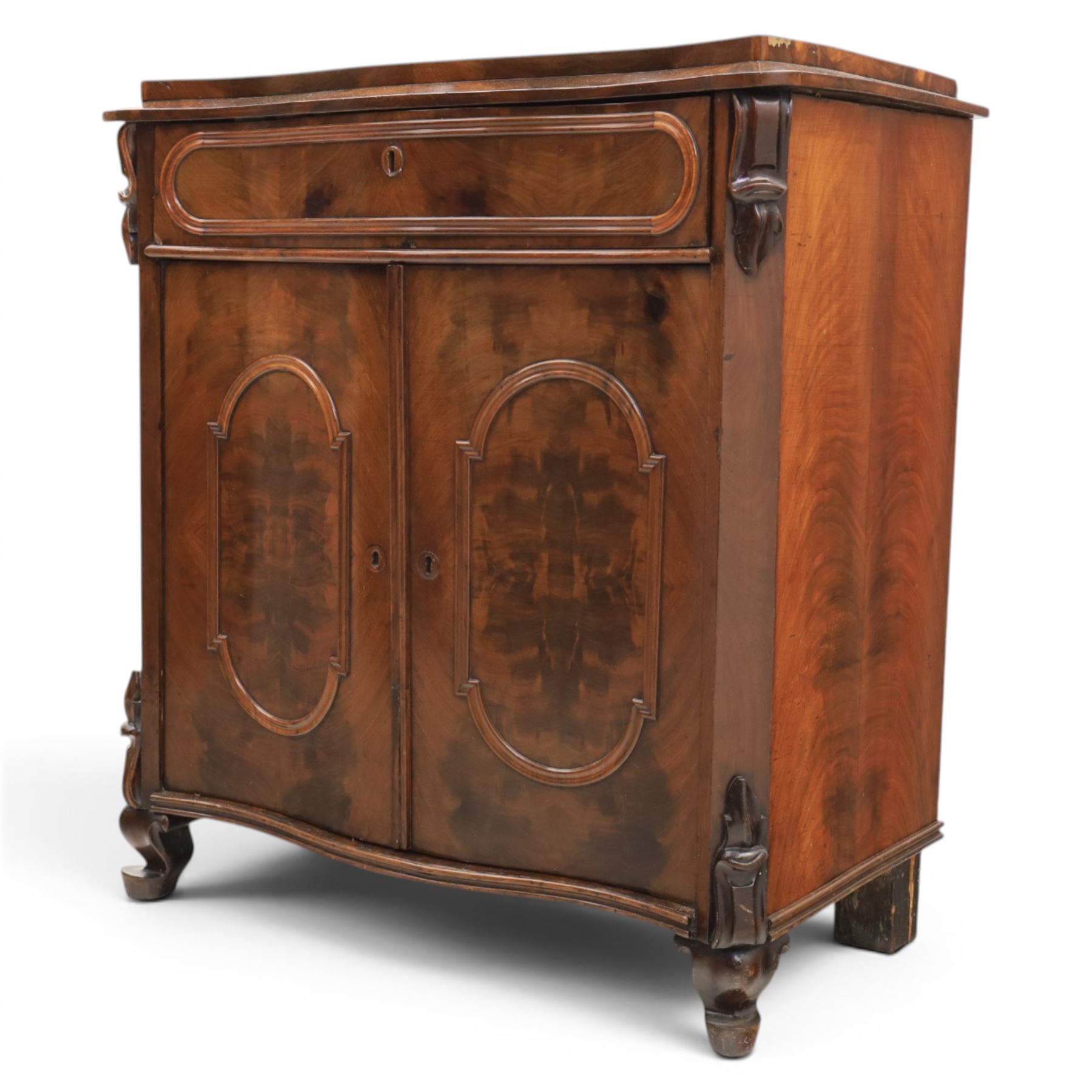 Victorian mahogany chiffonier, with serpentine front and book-matched veneered top, over a frieze drawer and cabinet, raised on pad feet