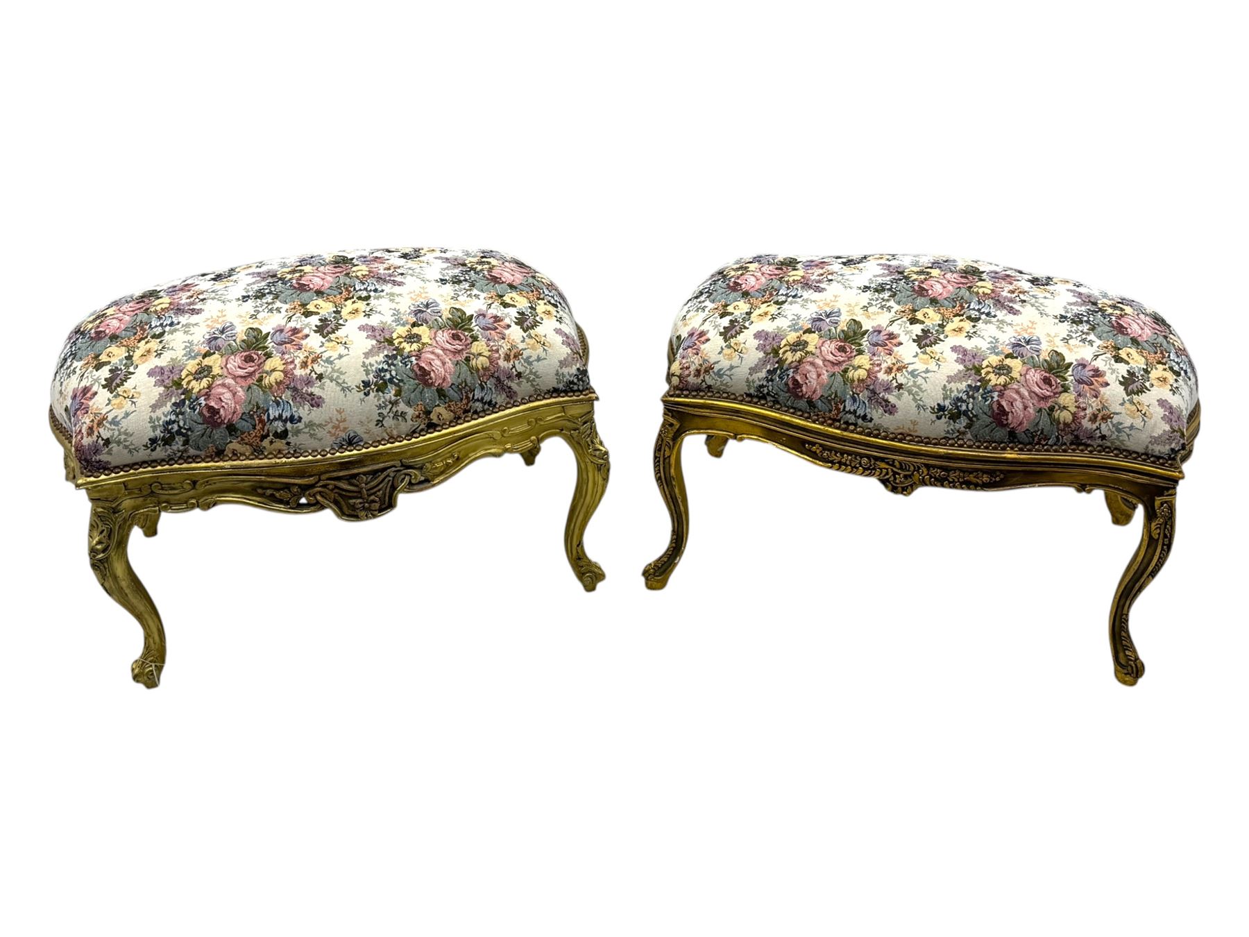 Pair of Louis XV-design giltwood stools, each upholstered in floral tapestry fabric, the carved frame adorned with scrolling foliage and shell motifs, raised on cabriole supports