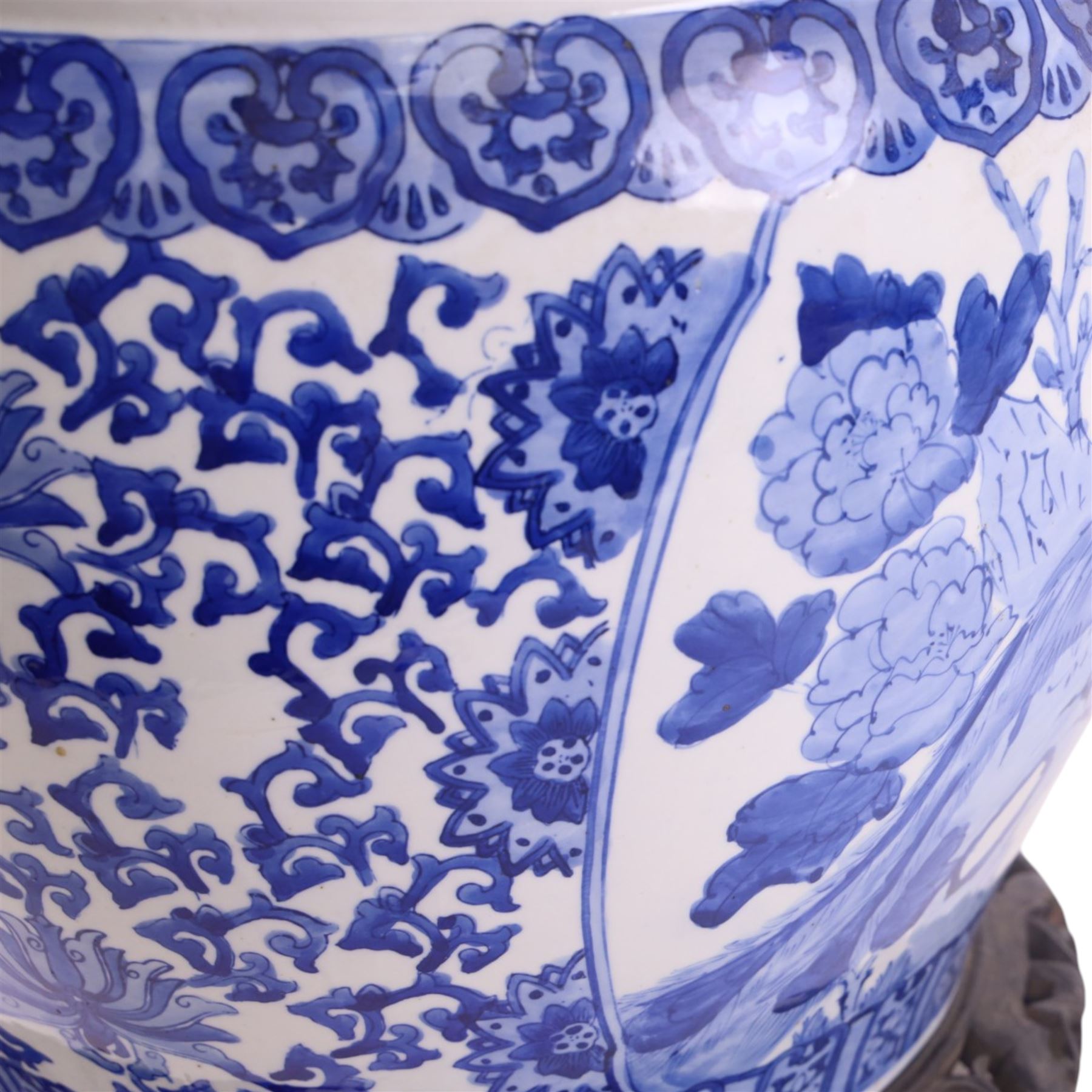20th century blue and white fishbowl planter, decorated with birds in blossoming branches, internally decorated with goldfish, upon a wooden base, H44cm