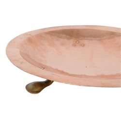 Arts and Crafts Birmingham Guild of Handicraft copper bowl, of circular form, the broad rim stamped with circles and fruiting sprigs, raised upon three cast brass feet, with impressed mark beneath The Birmingham Guild Ltd England, D30cm